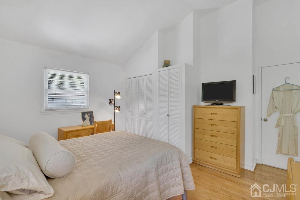 233 Amherst Avenue Colonia, NJ 07067 - Photo 22 of 56 a bedroom with a bed and flat screen tv