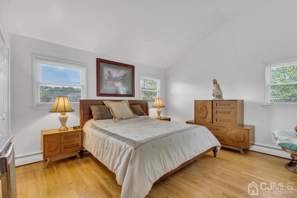 233 Amherst Avenue Colonia, NJ 07067 - Photo 23 of 56 a bedroom with a bed and a dresser with rug