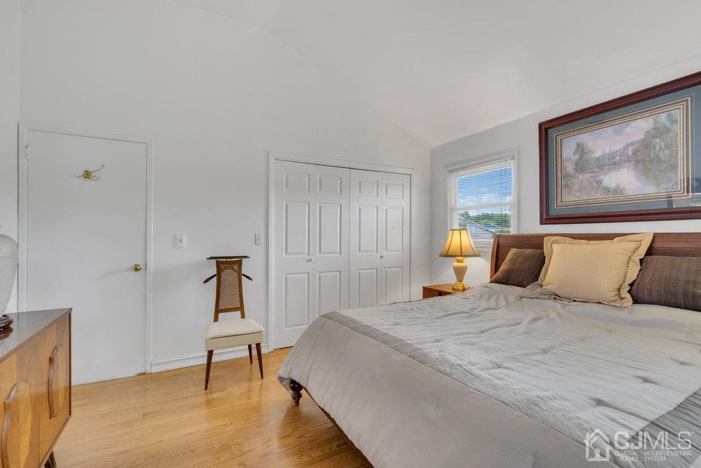 233 Amherst Avenue Colonia, NJ 07067 - Photo 24 of 56 a bedroom with a bed and a painting on the wall
