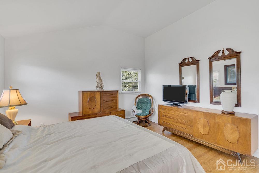 233 Amherst Avenue Colonia, NJ 07067 - Photo 25 of 56 a bedroom with furniture and a flat screen tv