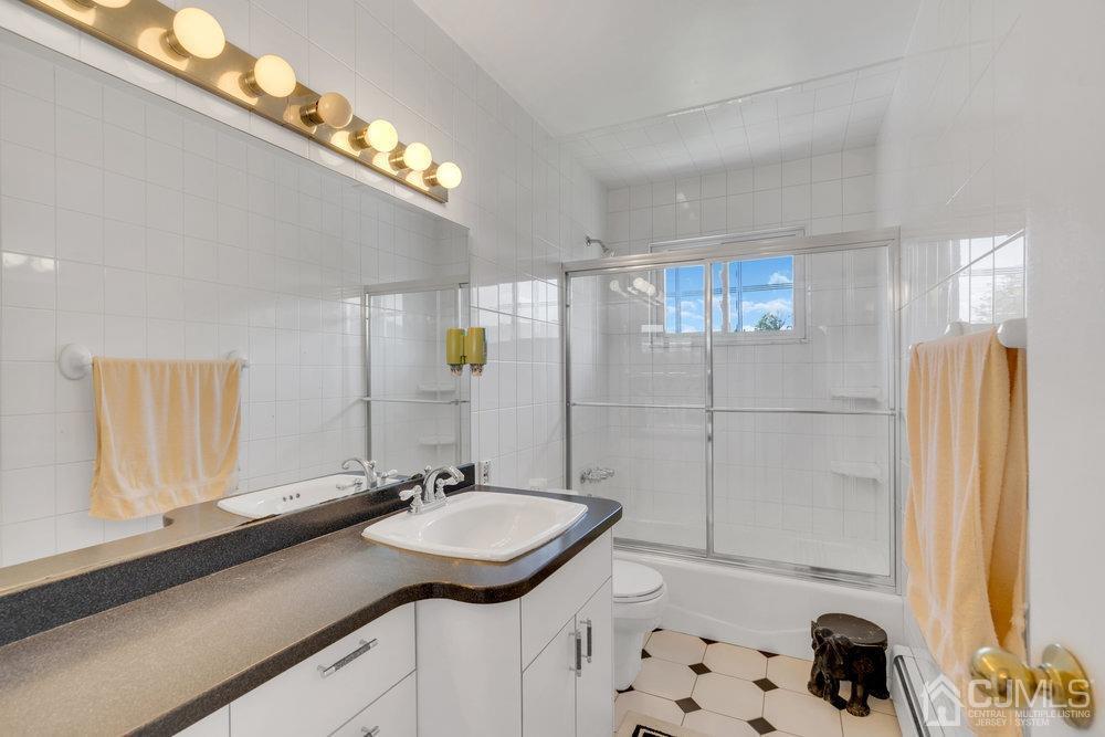 233 Amherst Avenue Colonia, NJ 07067 - Photo 26 of 56 a bathroom with a sink a double vanity and a mirror
