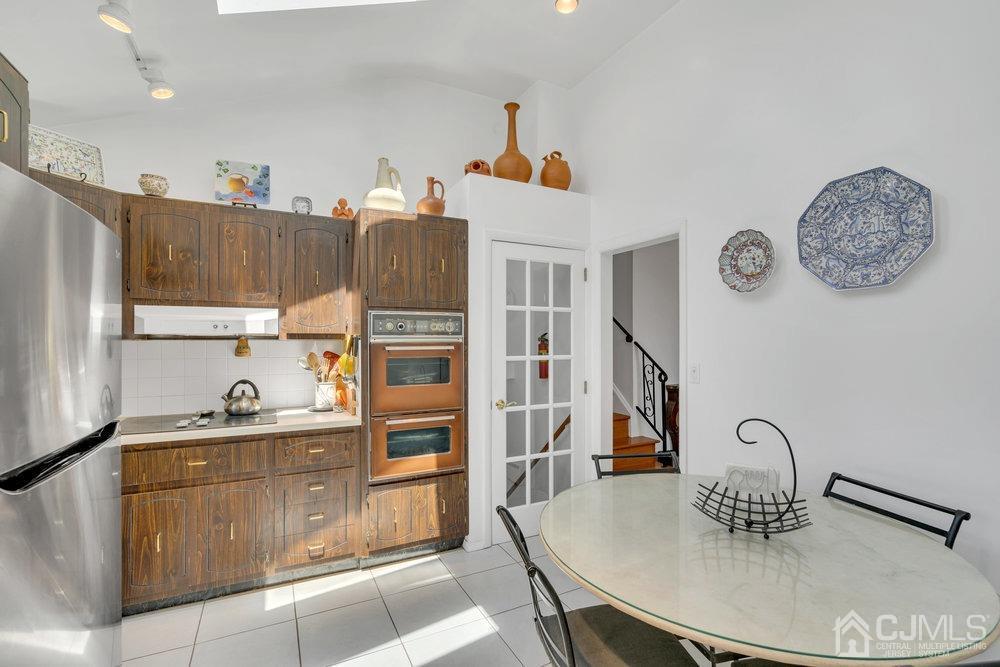 233 Amherst Avenue Colonia, NJ 07067 - Photo 28 of 56 a kitchen with granite countertop a table and chairs
