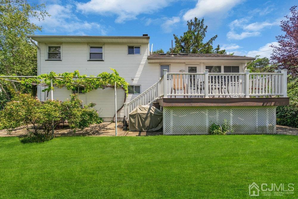 233 Amherst Avenue Colonia, NJ 07067 - Photo 41 of 56 a front view of a house with a garden and plants