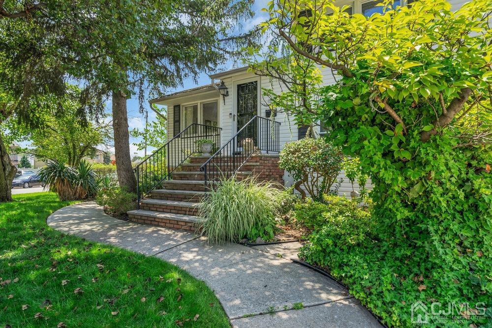 233 Amherst Avenue Colonia, NJ 07067 - Photo 51 of 56 a front view of a house with garden