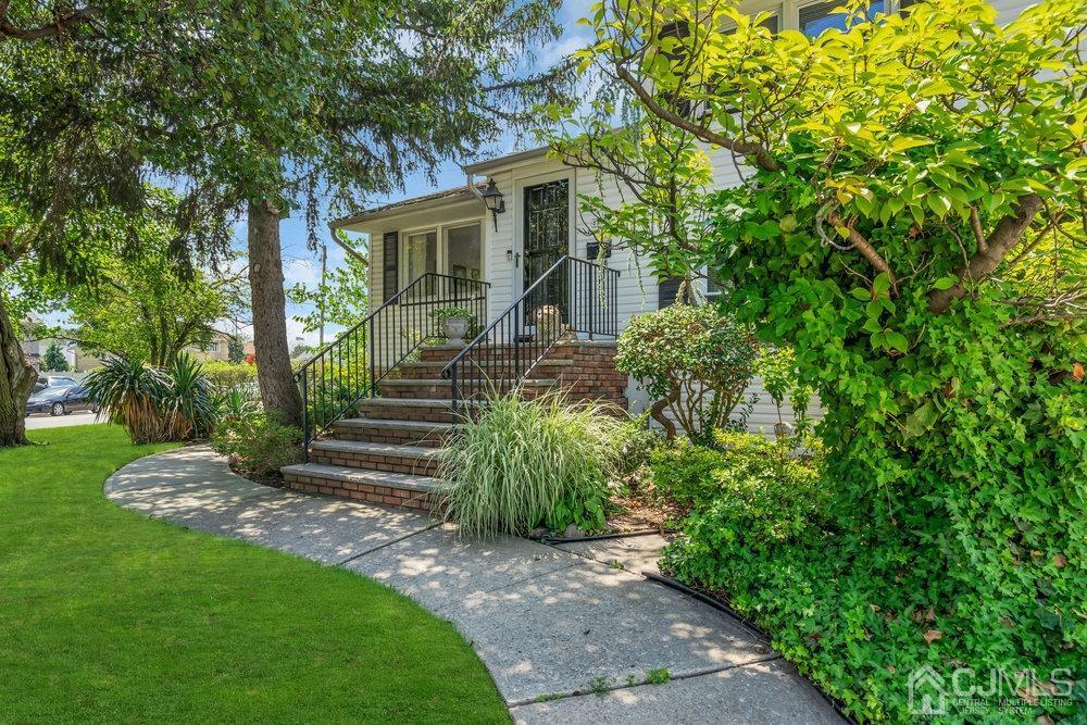 233 Amherst Avenue Colonia, NJ 07067 - Photo 8 of 56 a front view of a house with garden
