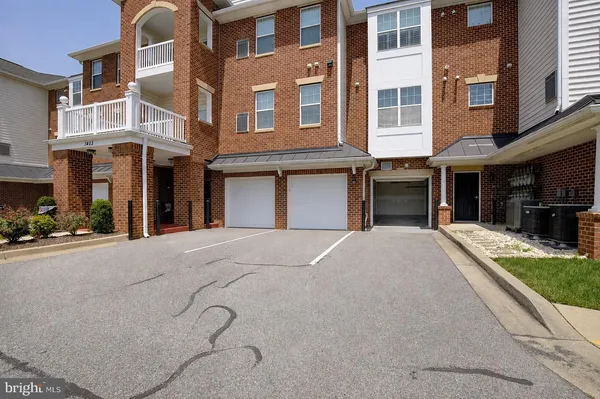 a front view of a building with a yard and a garage