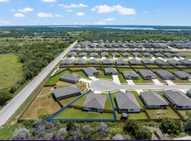 an aerial view of residential houses with outdoor space and river