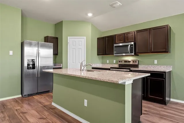 a kitchen with a refrigerator and a sink