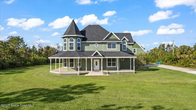 a front view of a house with a yard table and chairs