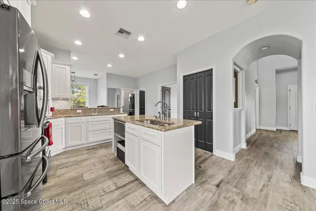 a dining room with furniture and a floor to ceiling window