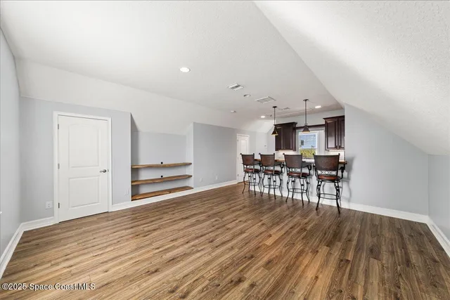 an aerial view of a house with garden space and street view