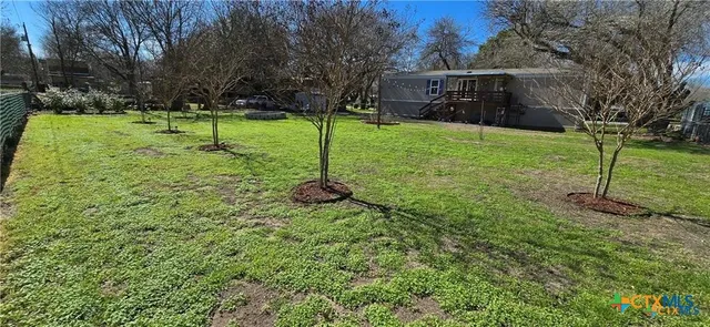 a roof deck with wooden table and chairs
