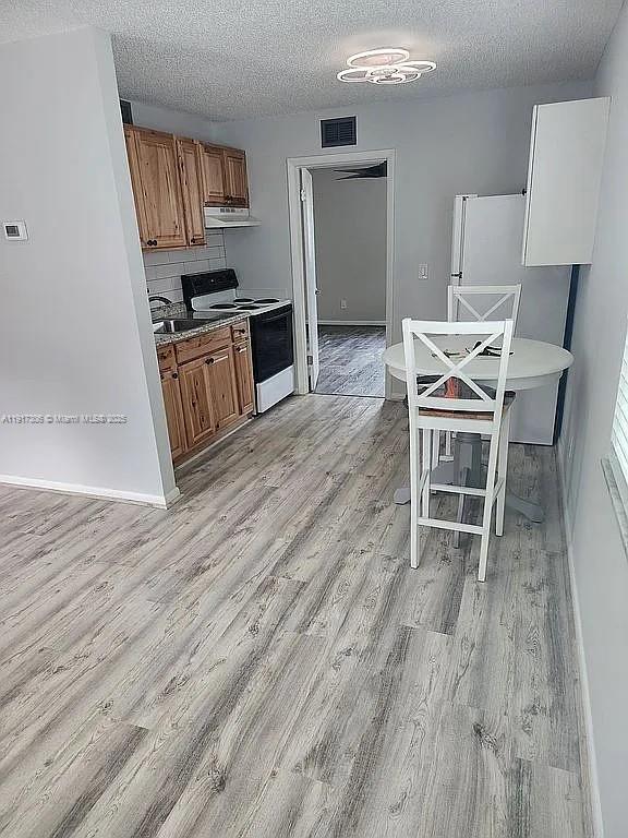 a view of a kitchen with microwave and furniture