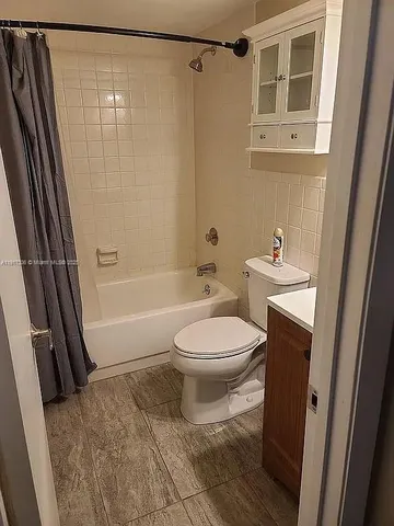 a bathroom with a toilet a sink and shower