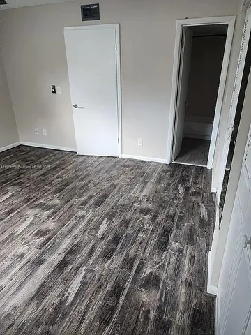 a view of a livingroom with wooden floor