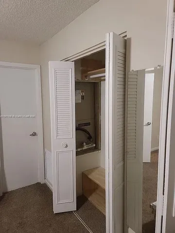 a view of a walk in closet and bathroom