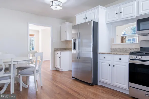 a kitchen with stainless steel appliances a refrigerator stove microwave and cabinets