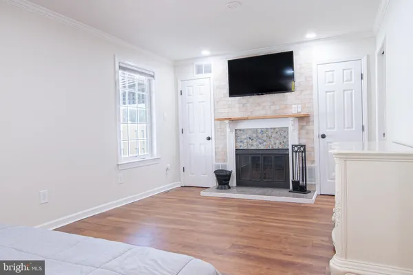 a living room with a fireplace and a flat screen tv