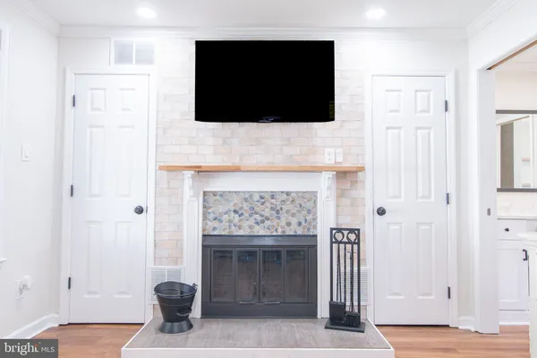 a living room with a fireplace and a flat screen tv