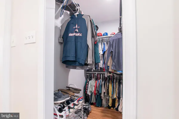 a view of walk in closet with clothes