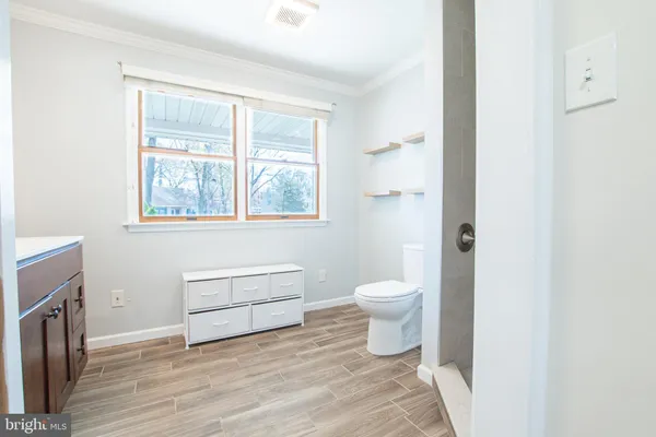 a bathroom with a toilet a sink and a window