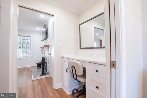 a en suite bathroom with a granite countertop sink a mirror and a shower