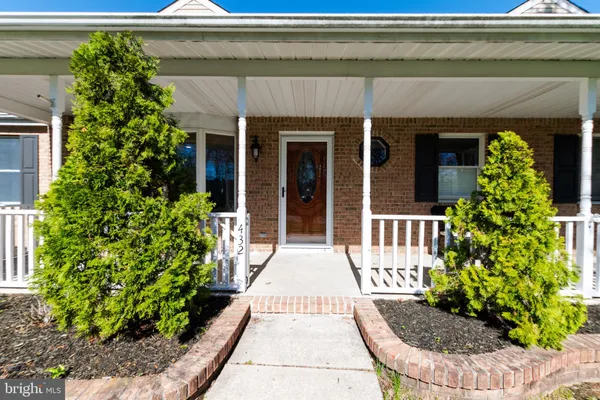 a view of a house with potted plants
