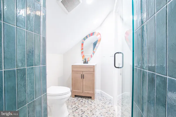 a bathroom with a shower a toilet and a sink