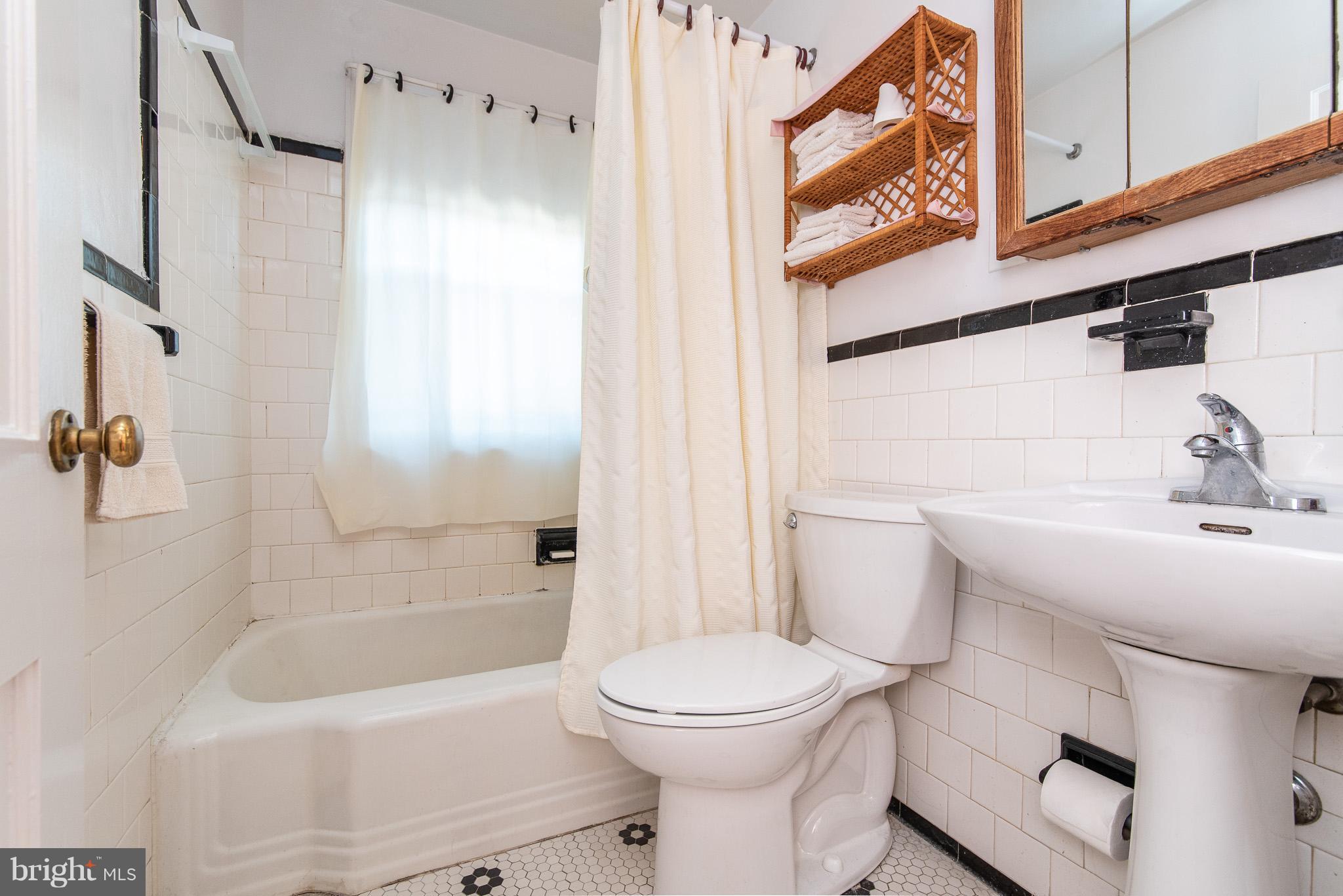 49 Hawthorne Road Baltimore, MD 21220 - Photo 21 of 31 a bathroom with a sink a toilet and shower