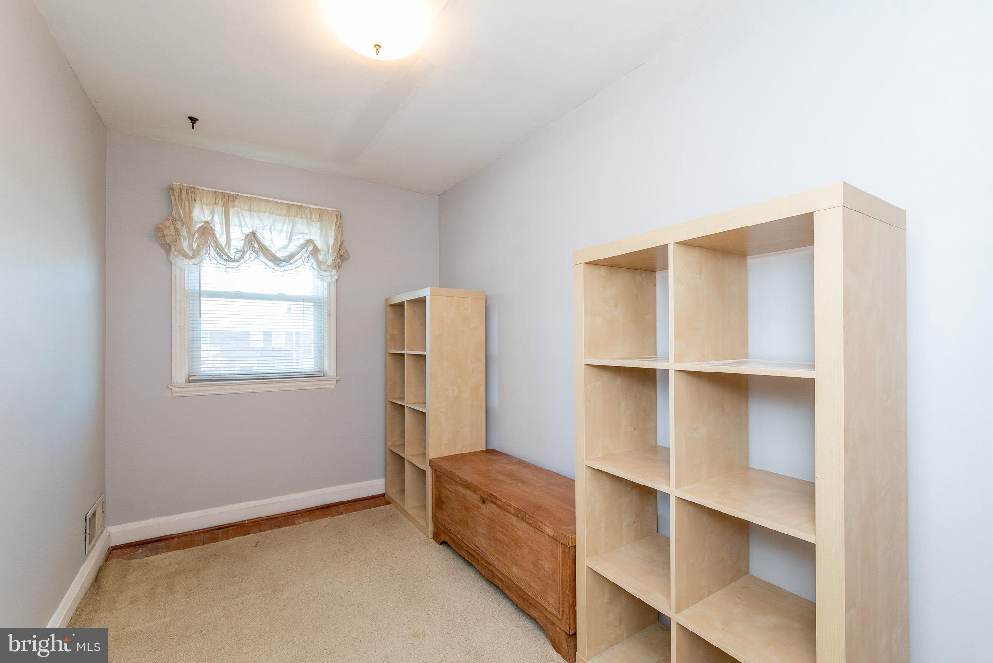 49 Hawthorne Road Baltimore, MD 21220 - Photo 22 of 31 a view of an empty room with cabinet and a window