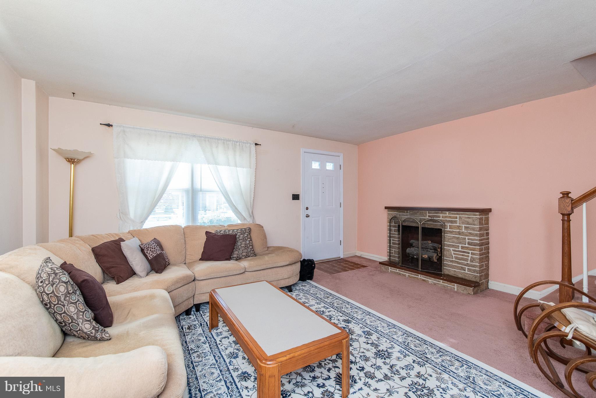 49 Hawthorne Road Baltimore, MD 21220 - Photo 5 of 31 a living room with furniture and a fireplace