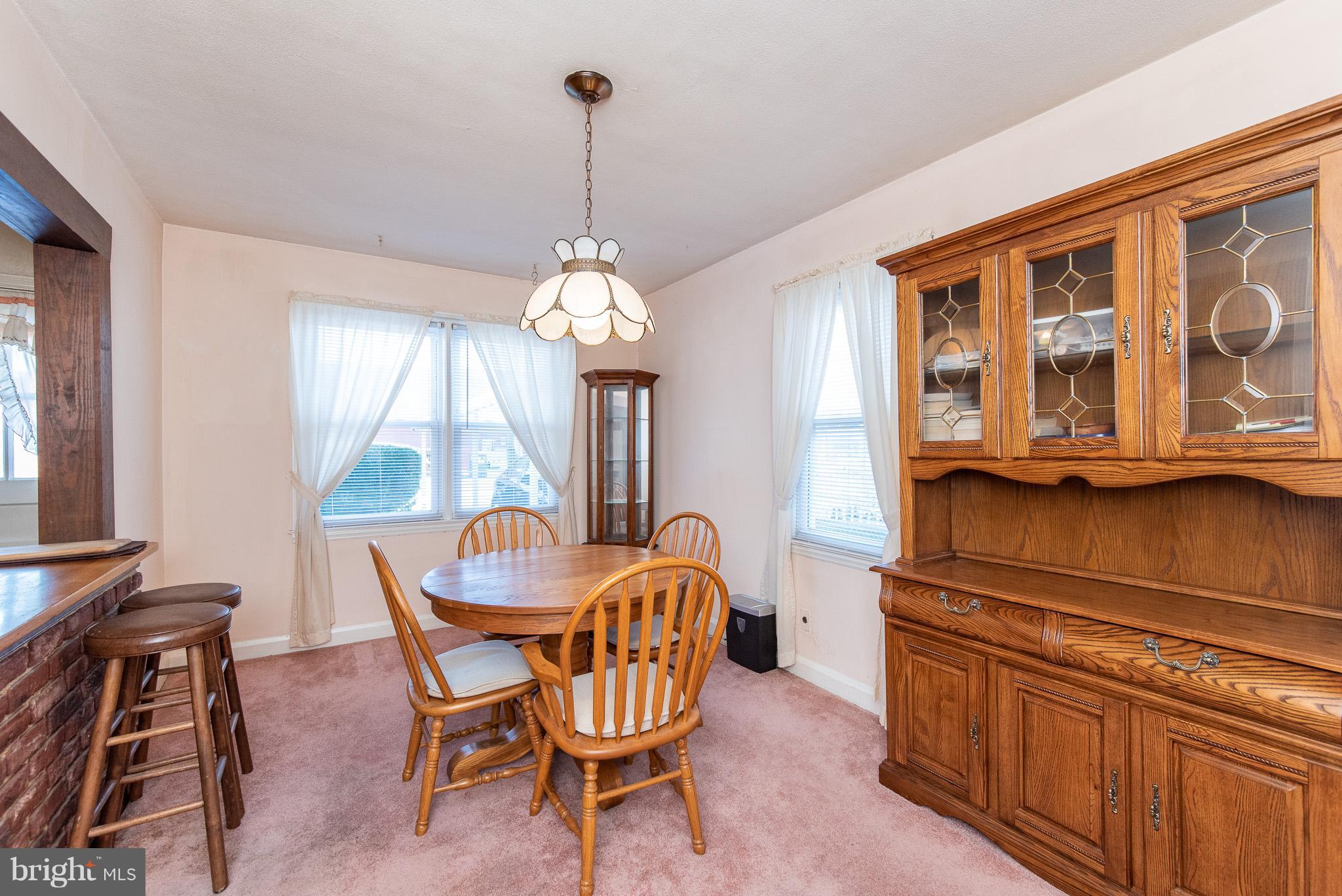 49 Hawthorne Road Baltimore, MD 21220 - Photo 6 of 31 a dining room with furniture a chandelier and wooden floor