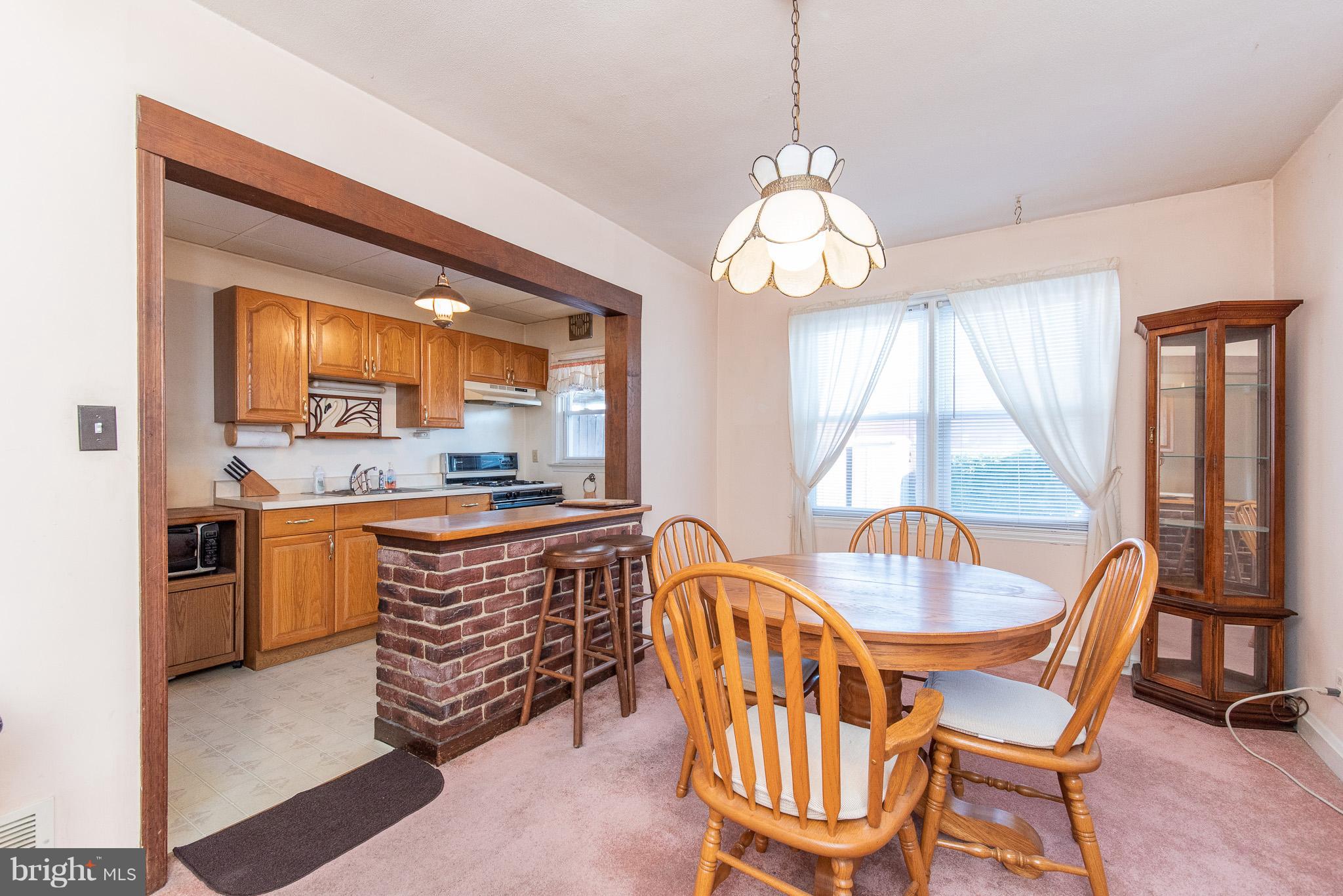 49 Hawthorne Road Baltimore, MD 21220 - Photo 7 of 31 a dining room with a wooden table and chairs