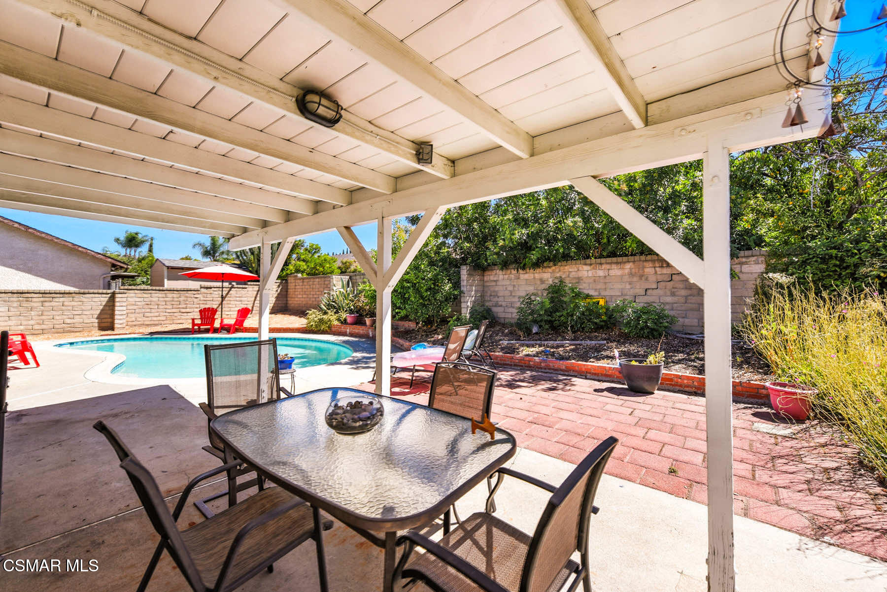 2238 Connell Avenue Simi Valley, CA 93063 - Photo 17 of 26 a view of a patio with a table and chairs under an umbrella with a small yard