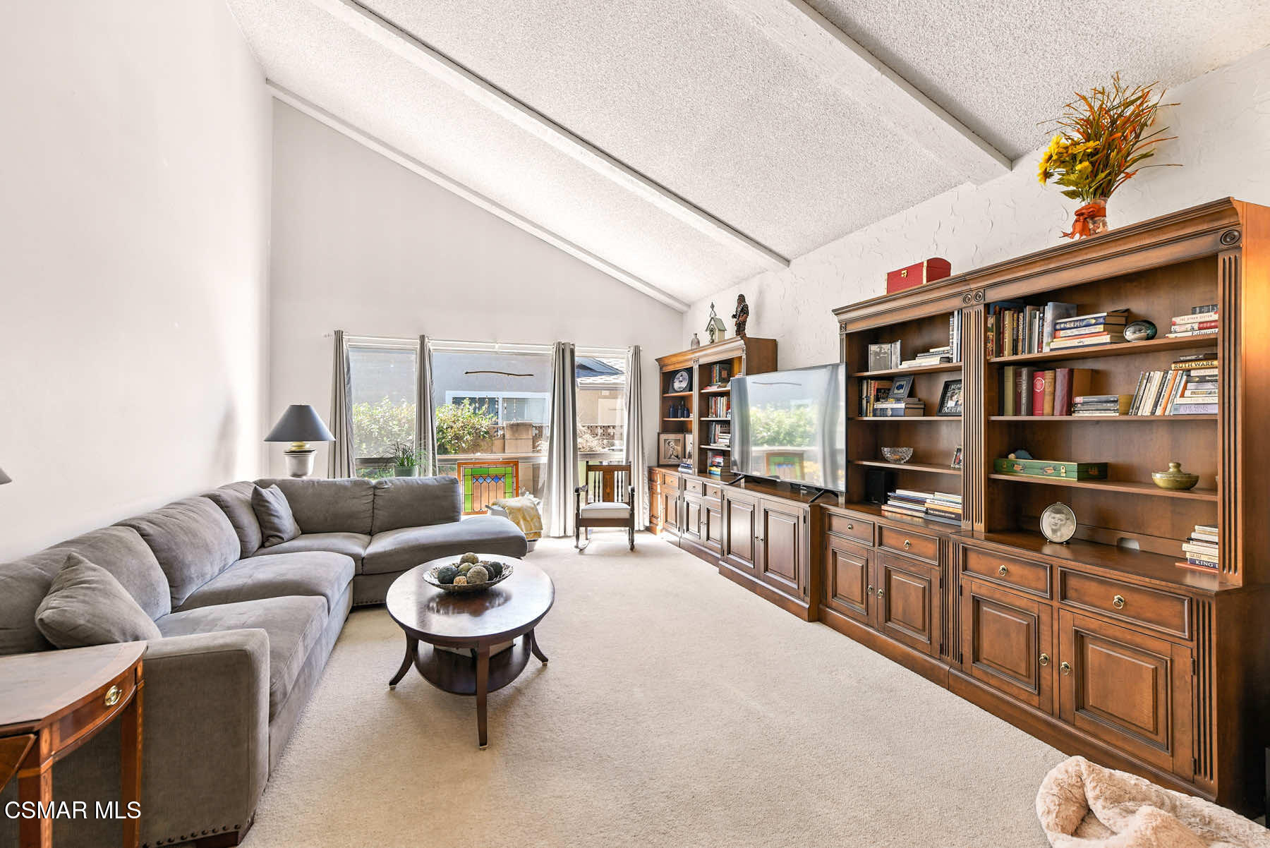 2238 Connell Avenue Simi Valley, CA 93063 - Photo 4 of 26 a living room with furniture a bookshelf and a large window