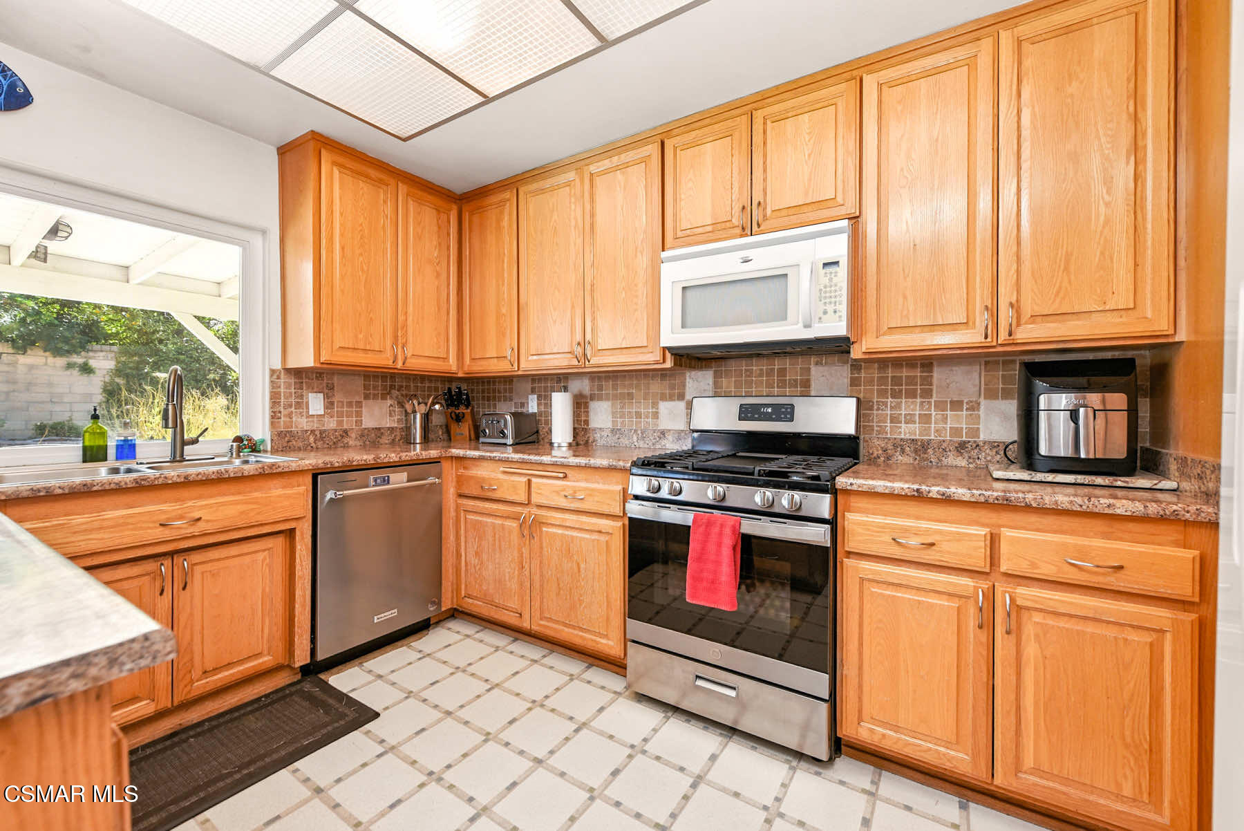 2238 Connell Avenue Simi Valley, CA 93063 - Photo 9 of 26 a kitchen with stainless steel appliances granite countertop a stove a sink and cabinets