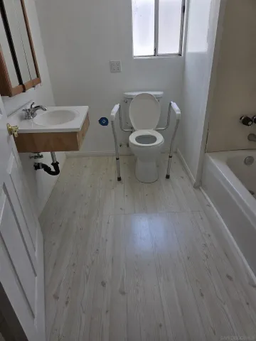a bathroom with a sink a toilet and tub