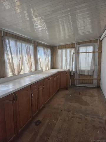 a room with wooden cabinets and staircase