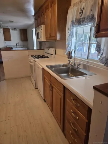 a kitchen that has a sink and a stove