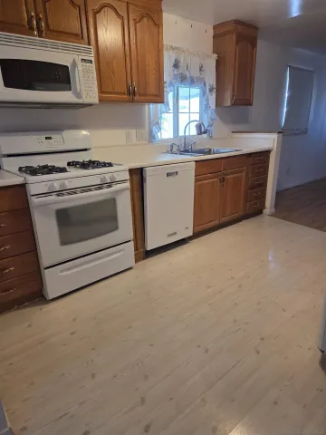 a kitchen with stainless steel appliances granite countertop a stove and a sink