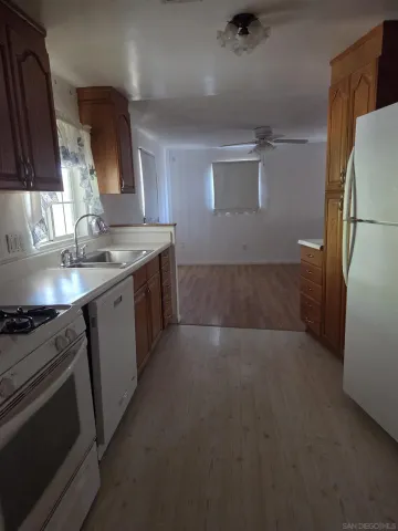 a kitchen with a sink stove and refrigerator