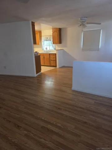 a view of a kitchen with wooden floor and a sink