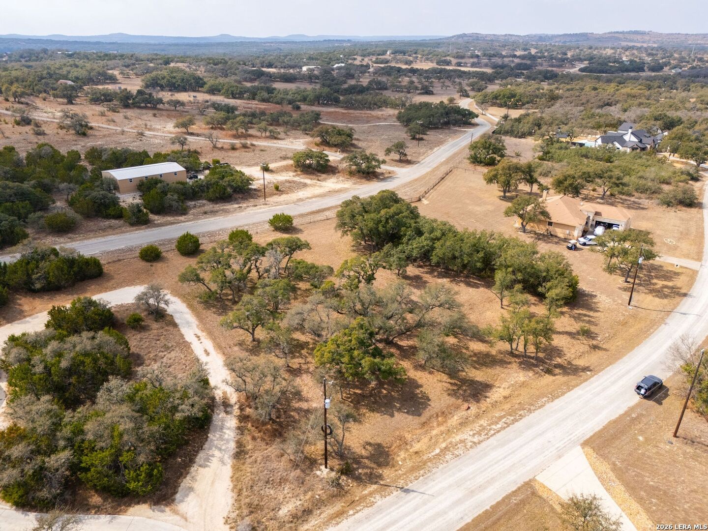 116 Riley Wood Blanco, TX 78606 - Photo 7 of 8 an aerial view of residential houses with outdoor space