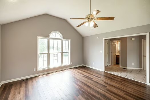 2029 Copper Kettle Circle Pleasant View, TN 37146 - Photo 12 of 58 an empty room with wooden floor fan and windows