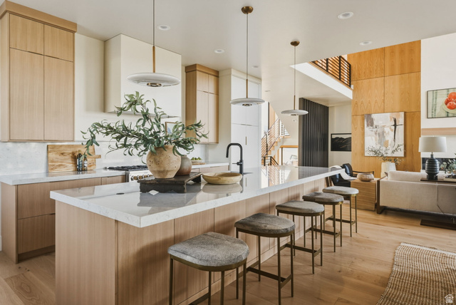 923 North Emery Lane Elk Ridge, UT 84651 - Photo 14 of 101 Open-concept kitchen featuring an oversized island with seating, integrated sink, and contemporary pendant lighting