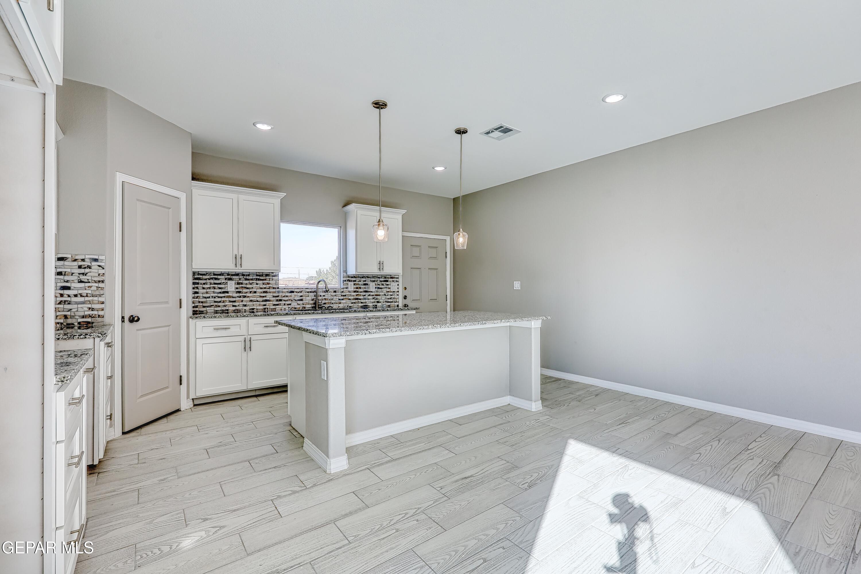 11607 Valle Bonito Road Socorro, TX 79927 - Photo 11 of 29 a large white kitchen with a sink