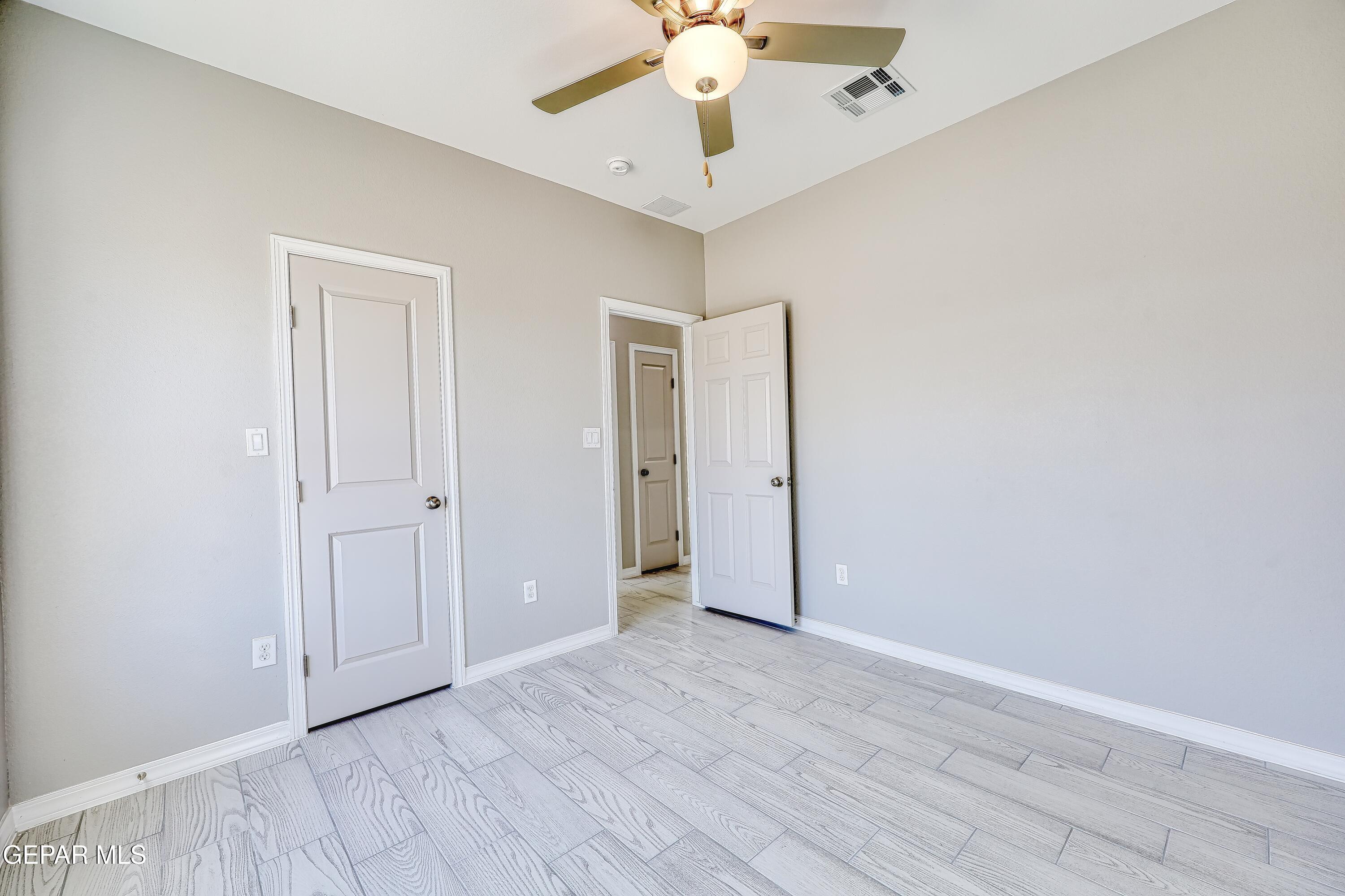 11607 Valle Bonito Road Socorro, TX 79927 - Photo 17 of 29 wooden floor in an empty room with a window