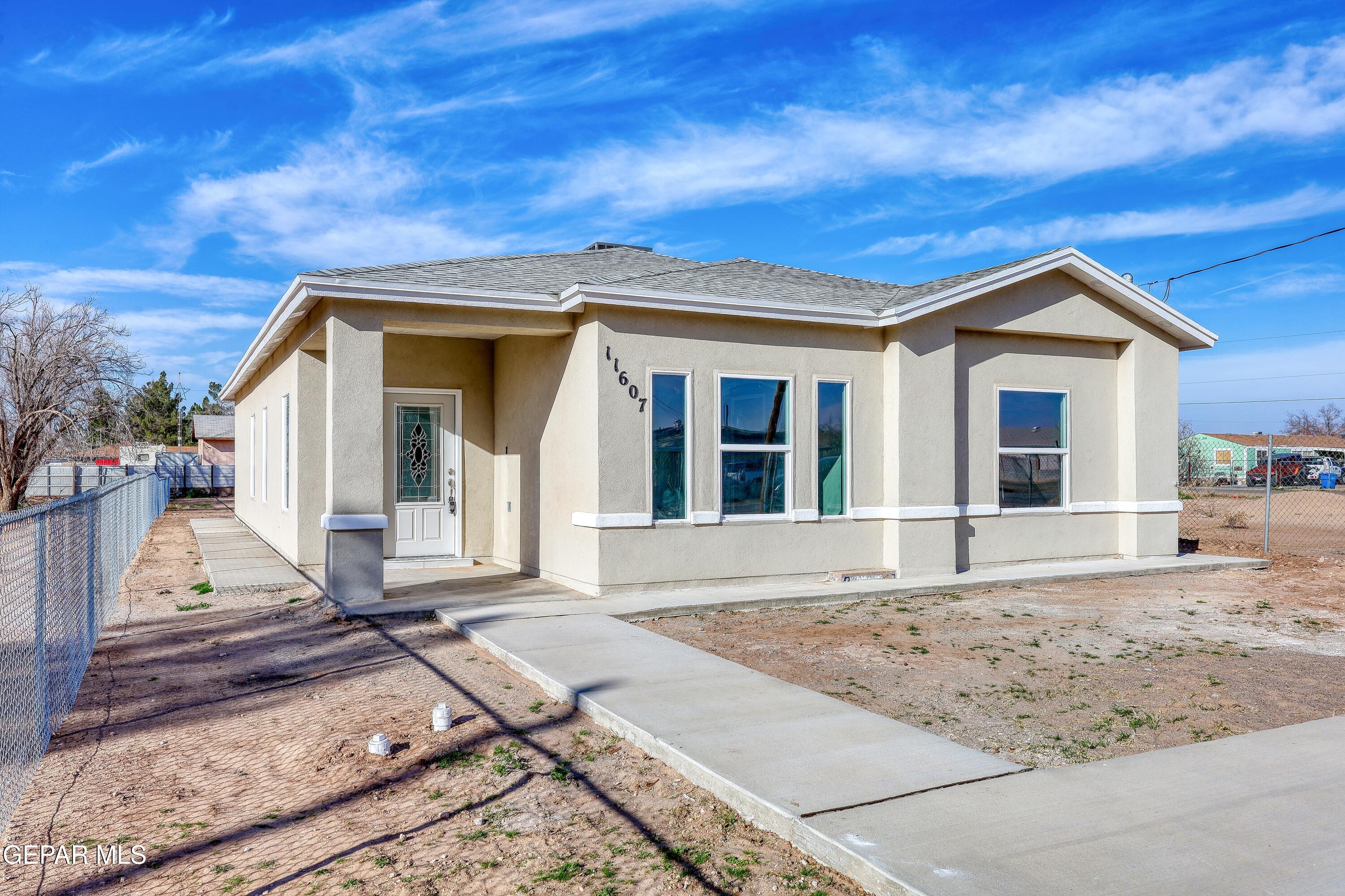 11607 Valle Bonito Road Socorro, TX 79927 - Photo 2 of 29 a front view of a house with a garden