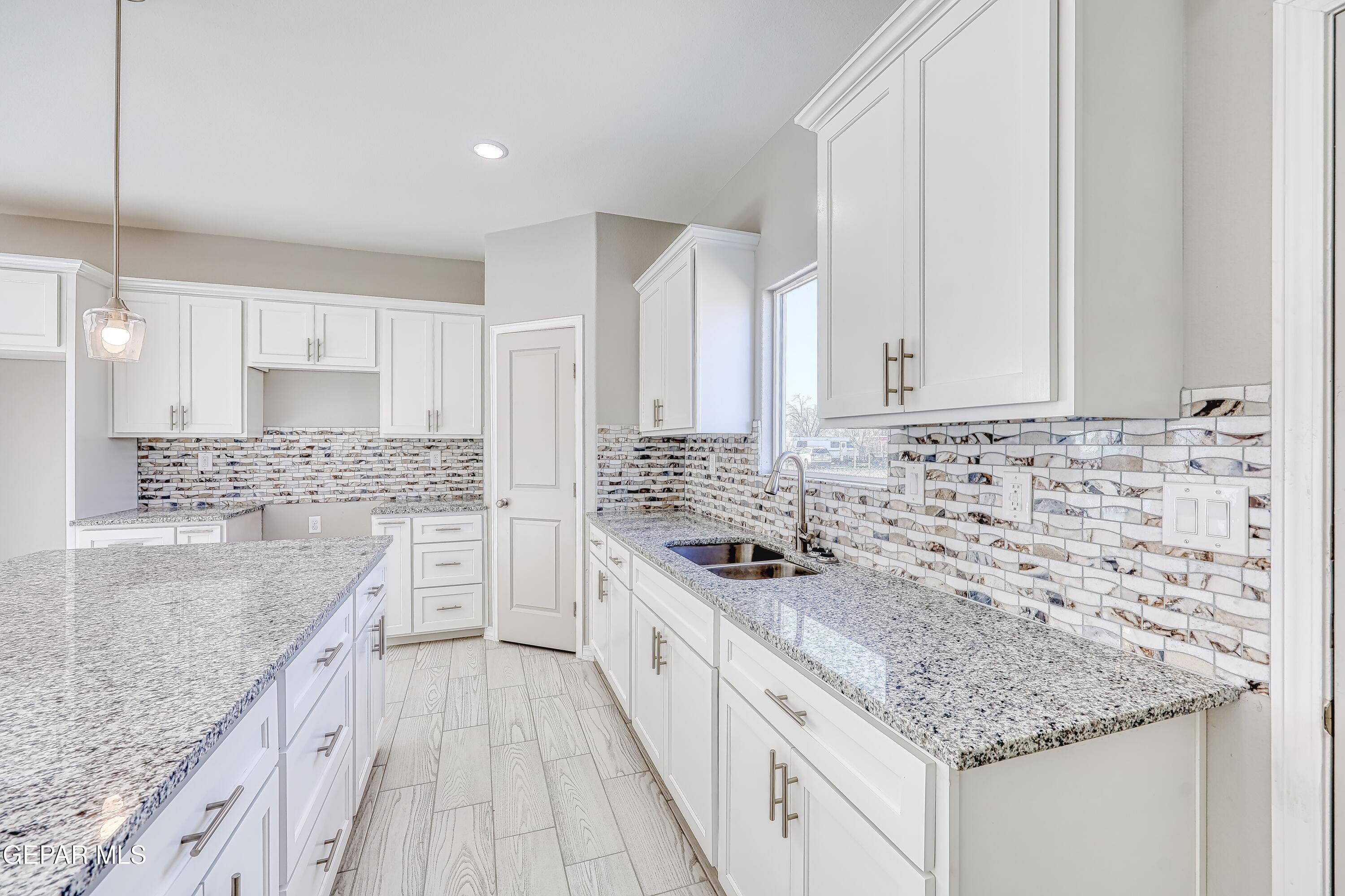 11607 Valle Bonito Road Socorro, TX 79927 - Photo 5 of 29 a kitchen with stainless steel appliances granite countertop a sink stove and cabinets