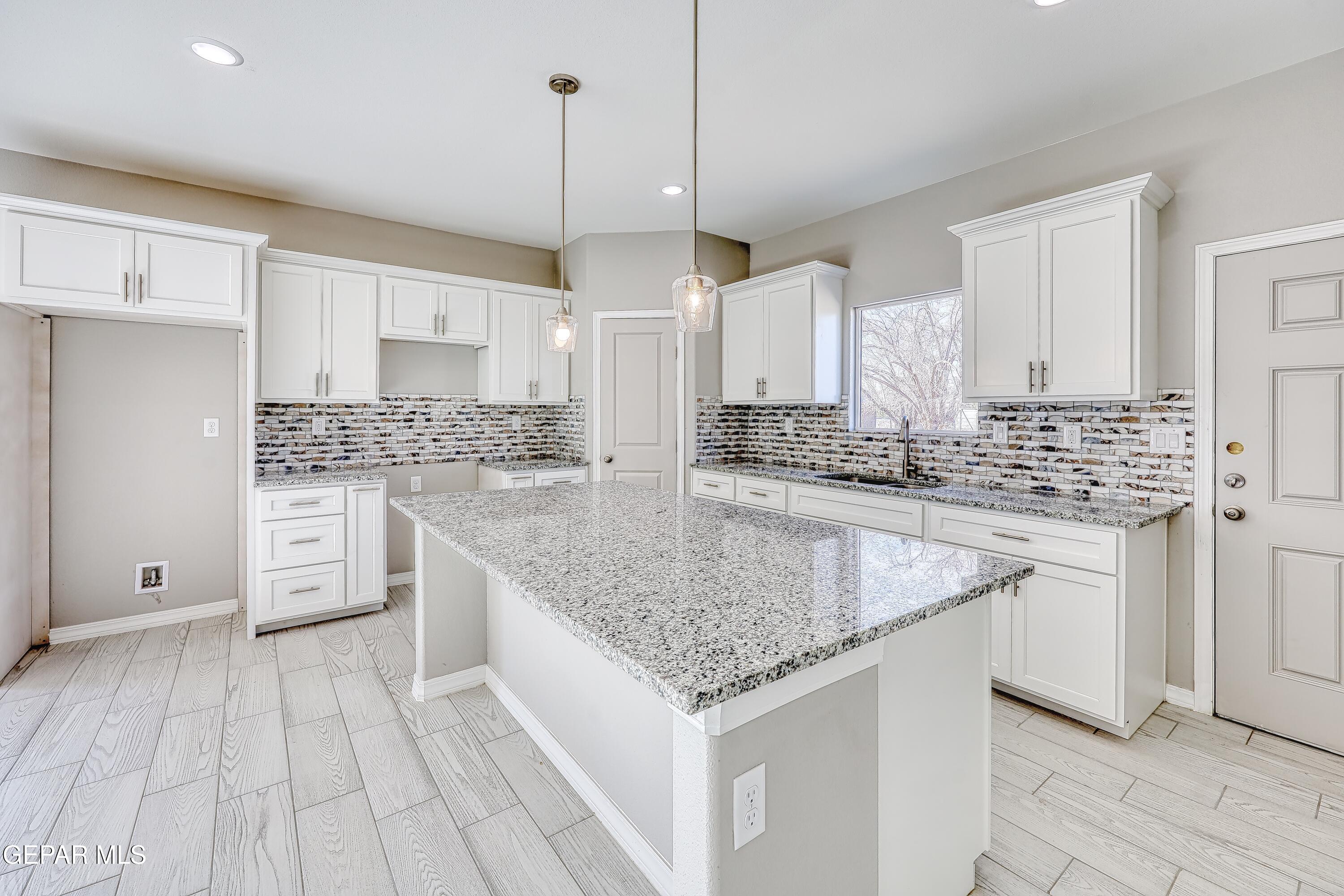 11607 Valle Bonito Road Socorro, TX 79927 - Photo 6 of 29 a kitchen with stainless steel appliances granite countertop a sink stove and cabinets